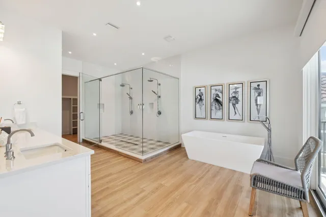 a spacious bathroom with a tub sink and shower
