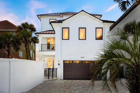 a view of a house with a palm tree