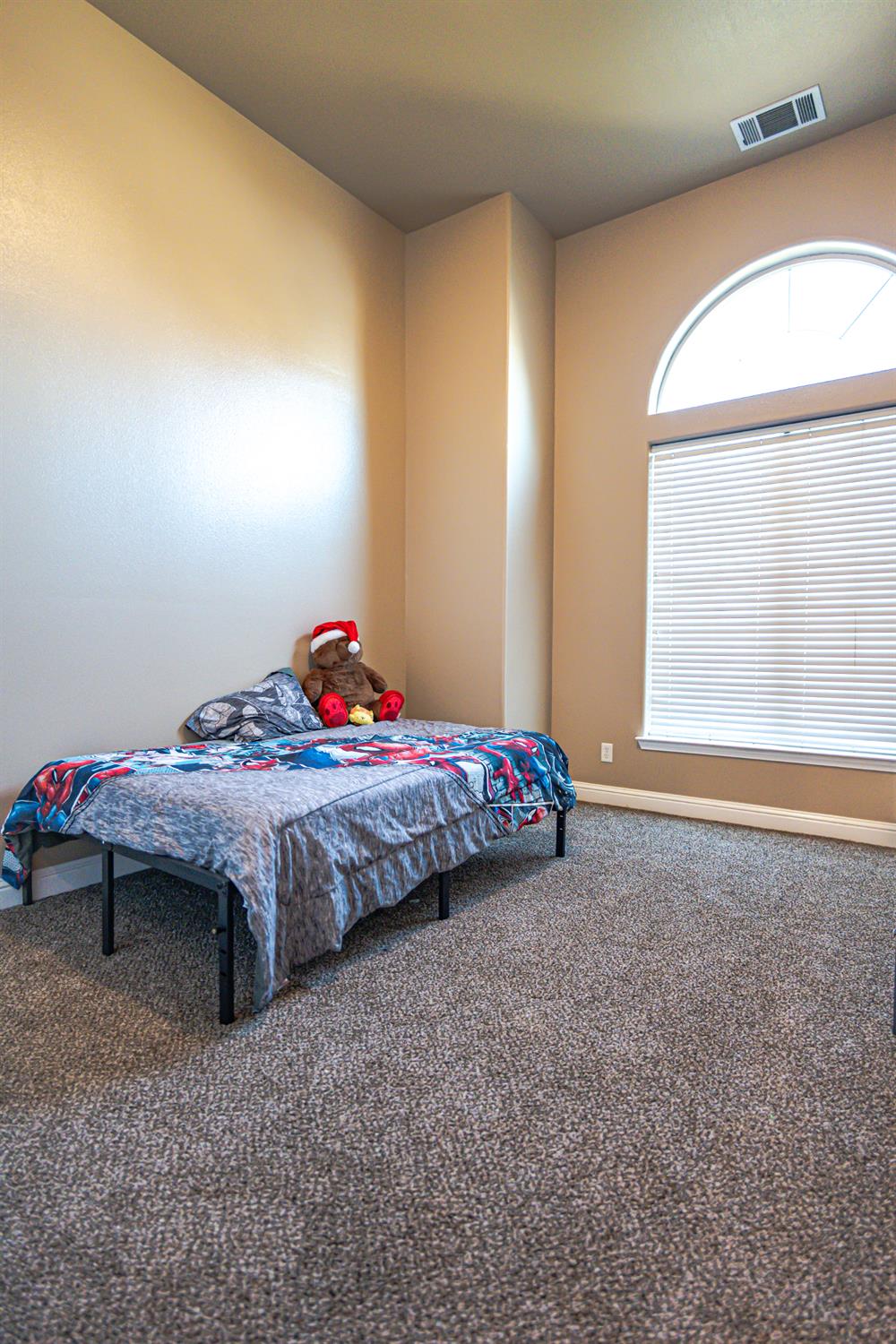 2506 Swift Avenue Clovis, CA 93611 - Photo 15 of 65 a bedroom with a bed and a window