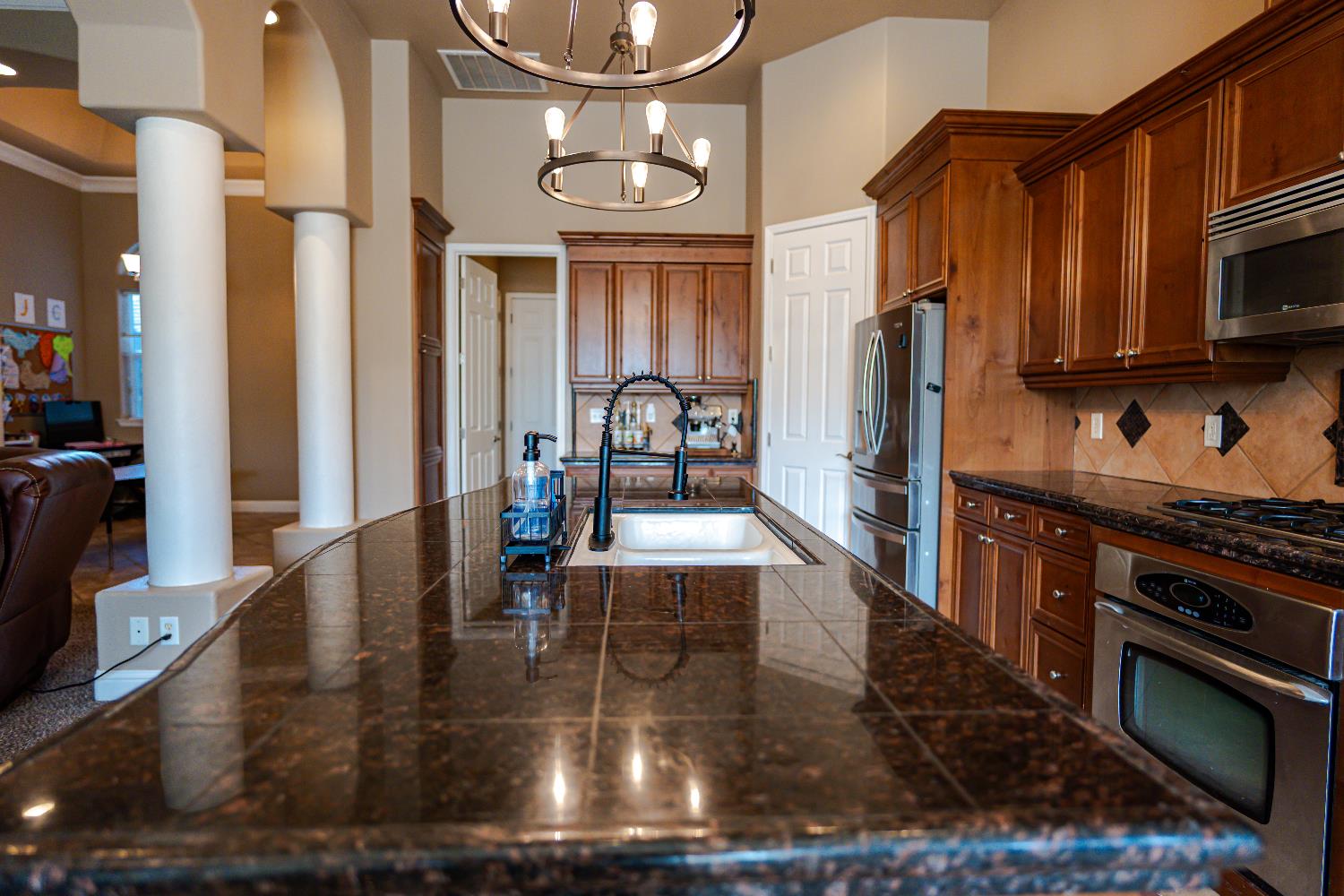 2506 Swift Avenue Clovis, CA 93611 - Photo 65 of 65 a kitchen with stainless steel appliances granite countertop a stove a refrigerator and a microwave