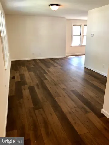 an empty room with wooden floor