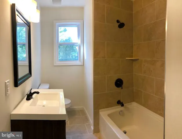 a bathroom with a sink a mirror and a bathtub