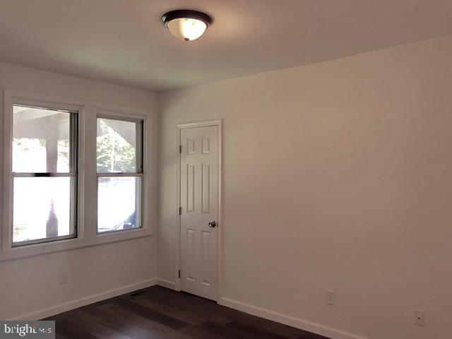 43 California Avenue, Unit A Clementon, NJ 08021 - Photo 9 of 11 an empty room with wooden floor and windows