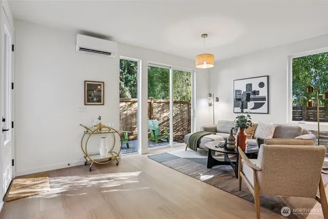 a living room with furniture a floor to ceiling window and a flat screen tv