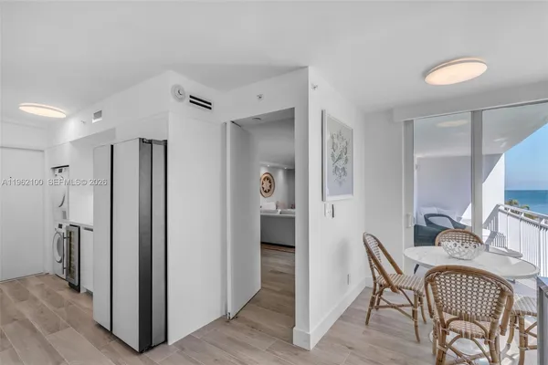 a view of a hallway with furniture and wooden floor