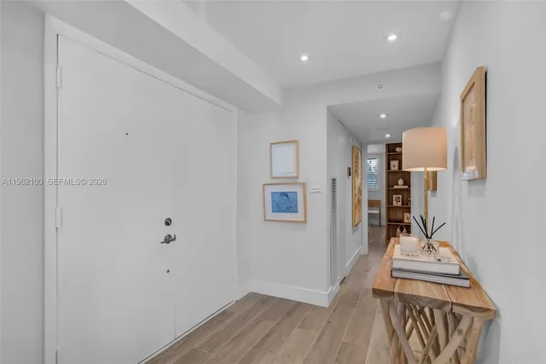a view of a hallway with wooden floor and workspace