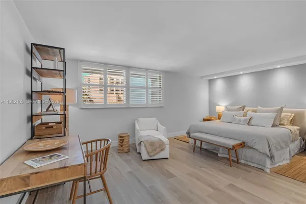 a bedroom with furniture and a window