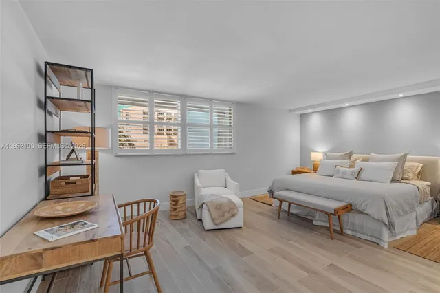 a bedroom with furniture and a window