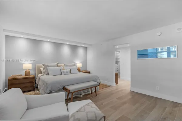 a bedroom with a bed and a night stand