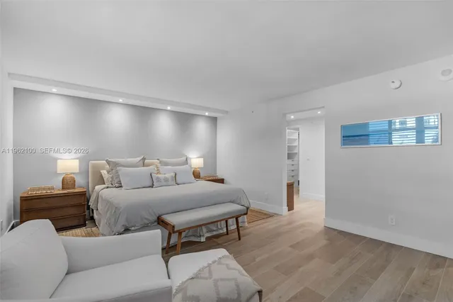 a bedroom with a bed and a night stand