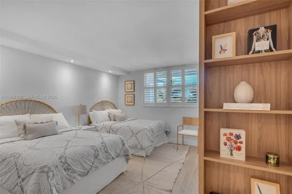 a bedroom with two beds and a window