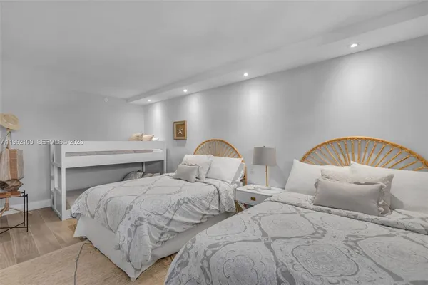 a bedroom with two beds and a chandelier