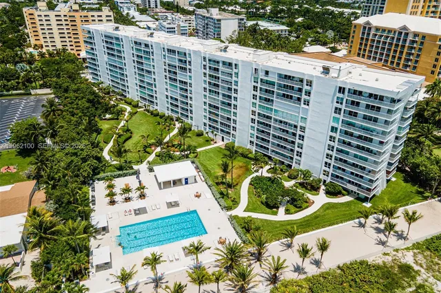 a view of a swimming pool with a yard