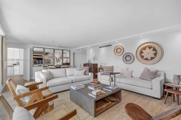 a living room with furniture a rug and a wall painting