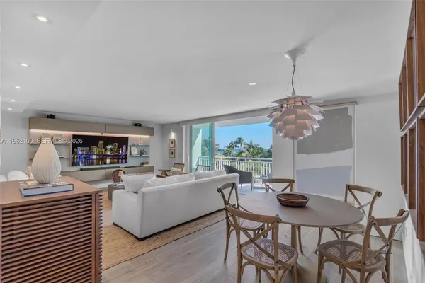 a living room with furniture a chandelier and a dining table