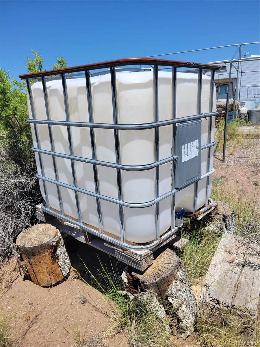6185 Hart Road Alamosa, CO 81101 - Photo 11 of 19 a wooden bench sitting in front of a building