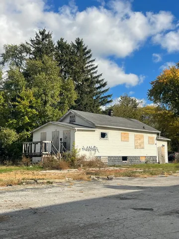 a view of a house with a yard and sitting area