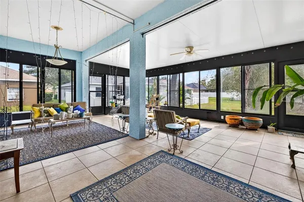 a living room with furniture and floor to ceiling windows