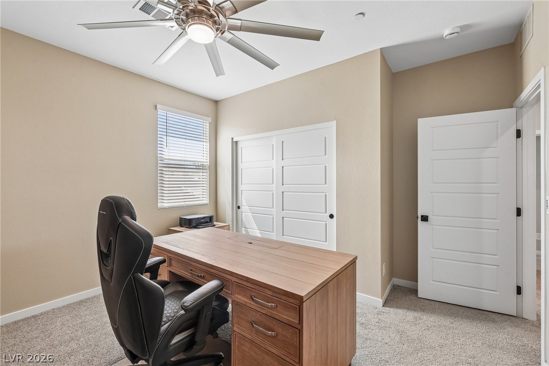 194 Viento Ridge Street Henderson, NV 89012 - Photo 42 of 72 A quiet home workspace stands ready with neutral walls and soft plush carpeting.