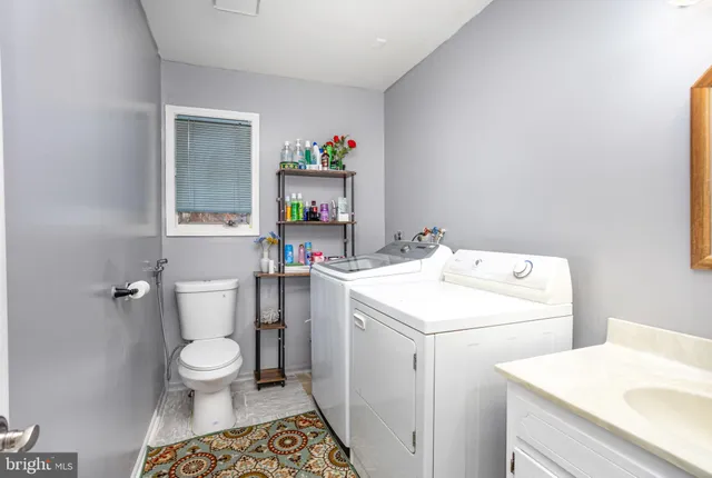 a bathroom with a sink a toilet and a vanity