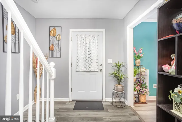 a view of entryway with wooden floor and window