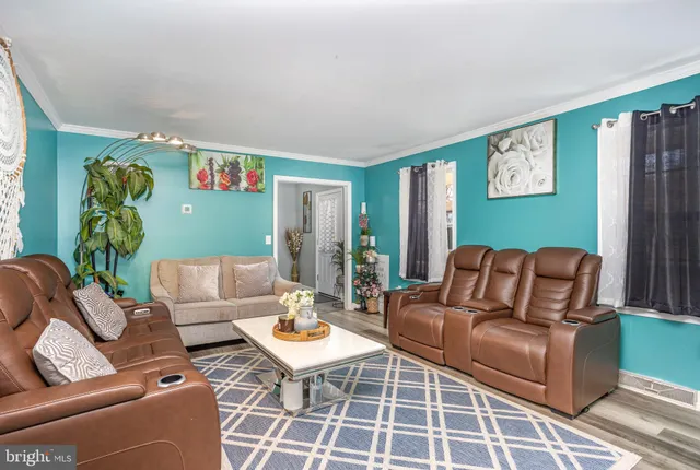 a living room with furniture and painting on the wall