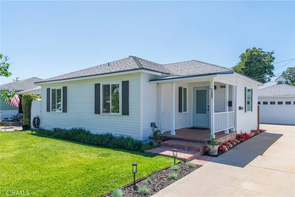 a front view of house with yard outdoor seating and barbeque oven
