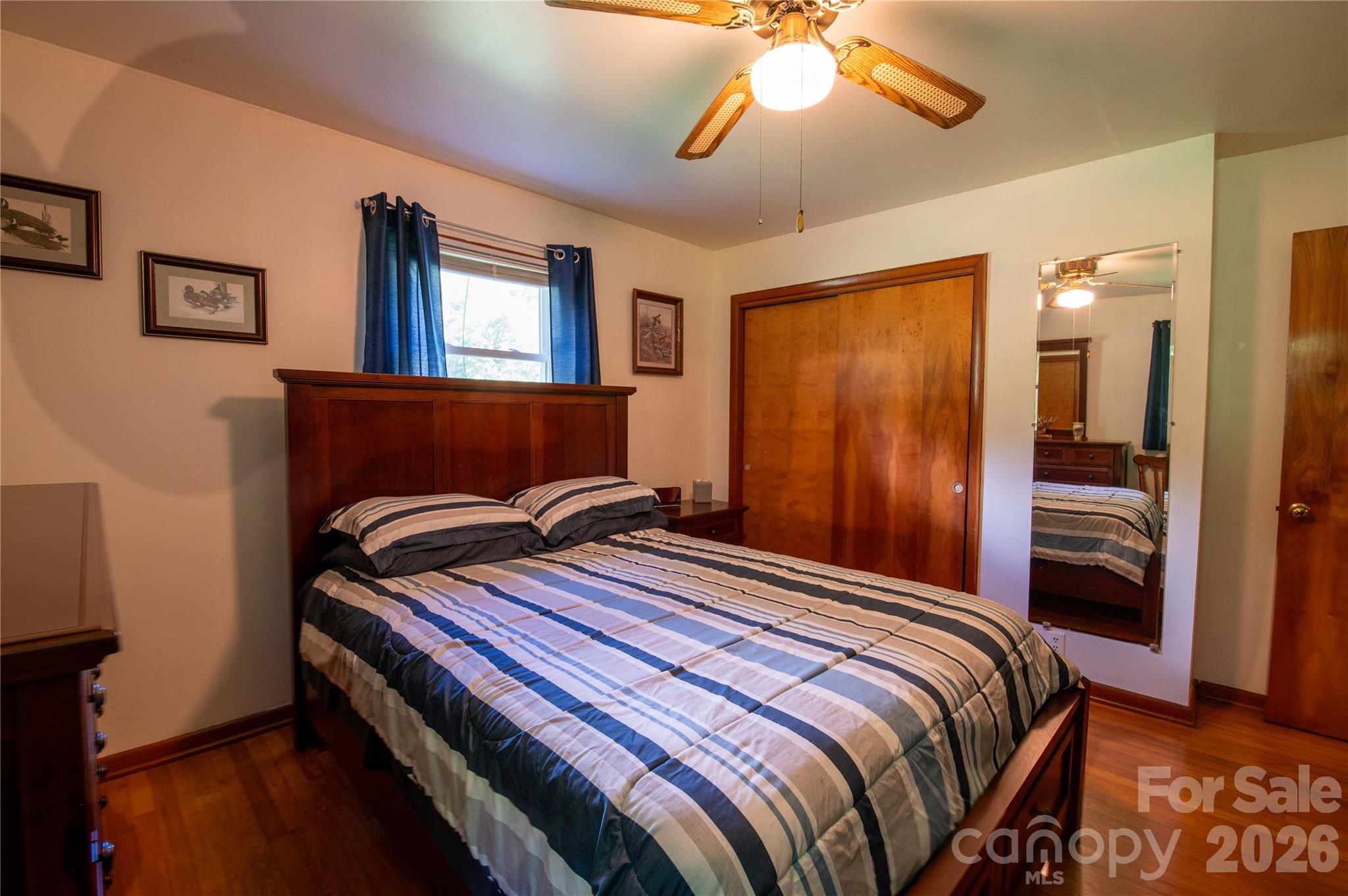 40 Double Island Road Burnsville, NC 28714 - Photo 23 of 38 a bedroom with a bed and a chandelier
