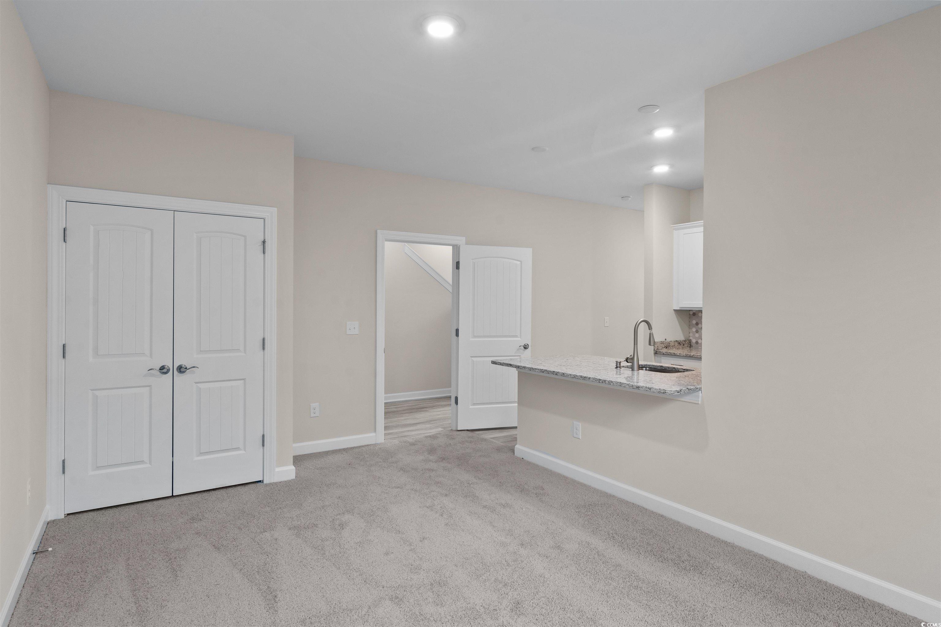 1906 Woodrush Loop Little River, SC 29566 - Photo 12 of 40 Interior space with sink and light carpet