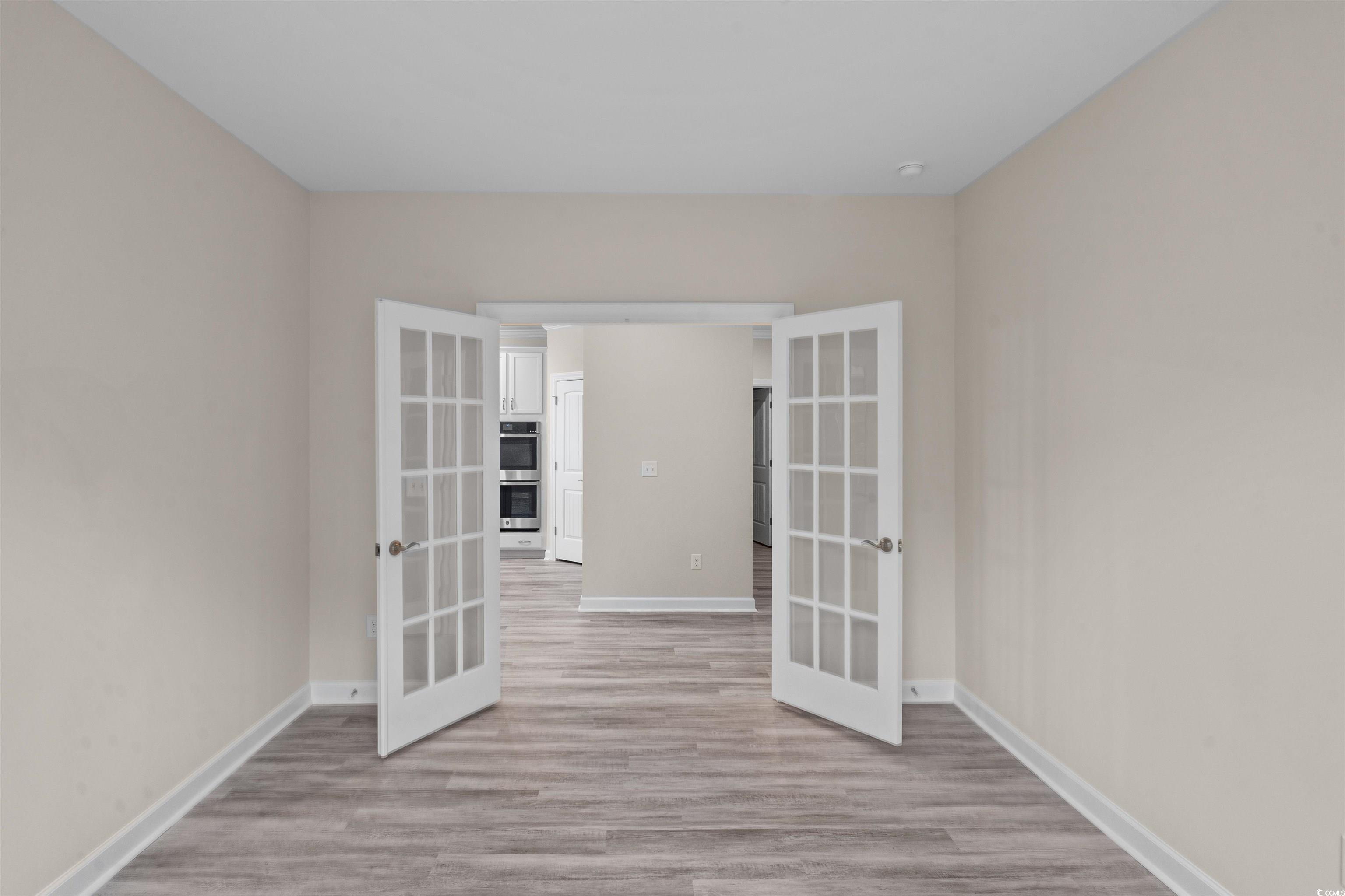 1906 Woodrush Loop Little River, SC 29566 - Photo 14 of 40 Spare room with light wood-type flooring and french doors
