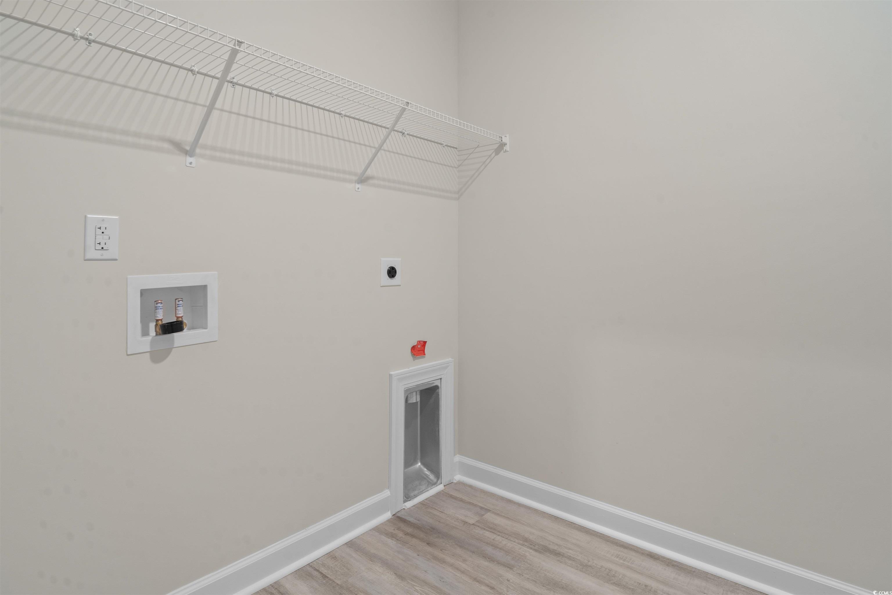 1906 Woodrush Loop Little River, SC 29566 - Photo 25 of 40 Laundry room featuring electric dryer hookup, hardwood / wood-style flooring, and washer hookup