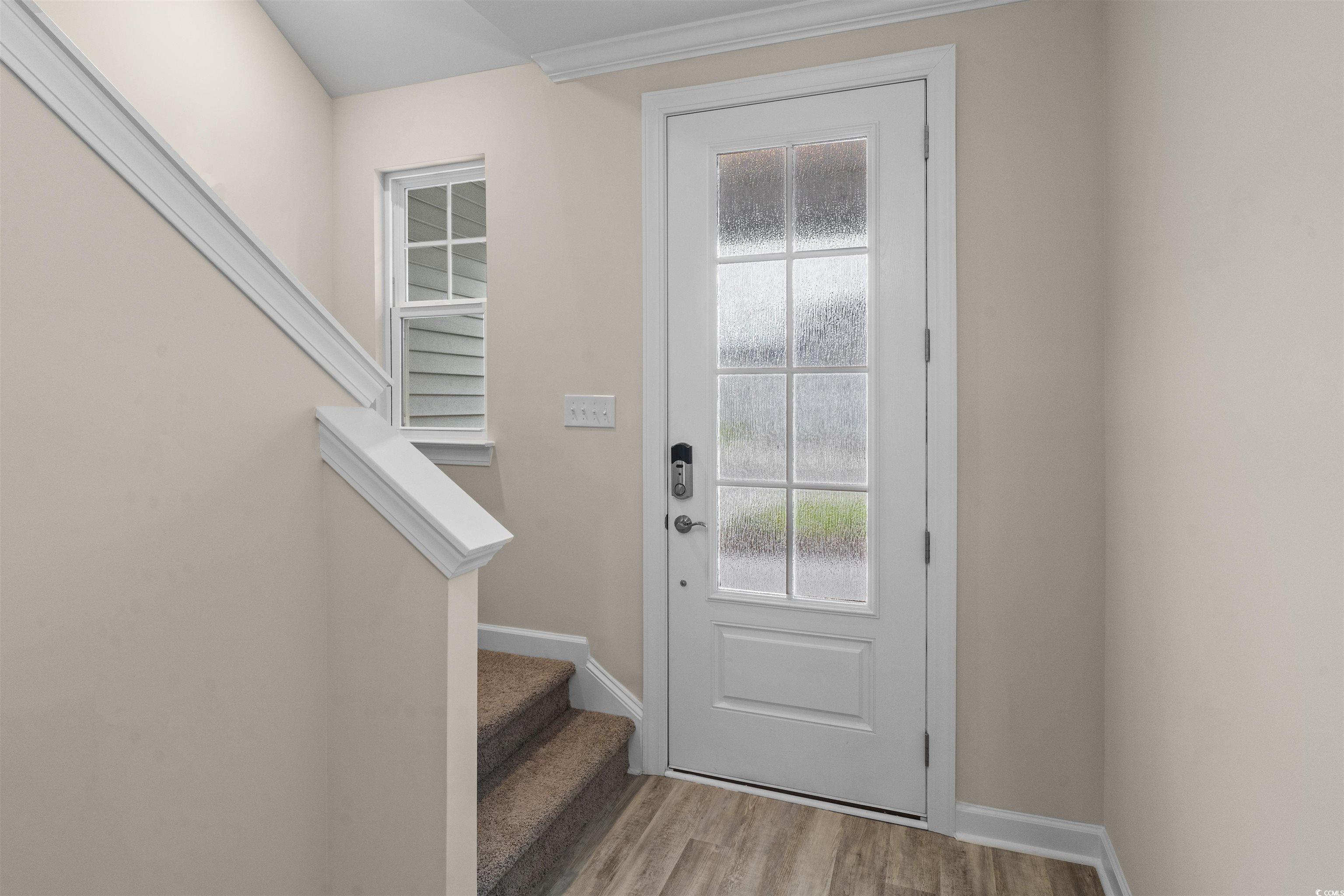 1906 Woodrush Loop Little River, SC 29566 - Photo 4 of 40 Doorway to outside featuring wood-type flooring and ornamental molding