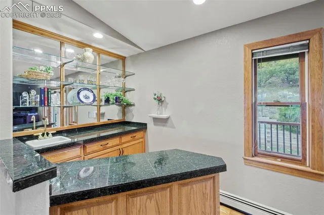 a kitchen with stainless steel appliances granite countertop a sink and a wooden cabinets