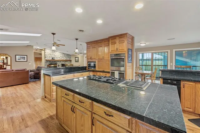 a kitchen with stainless steel appliances granite countertop counter space a sink and cabinets