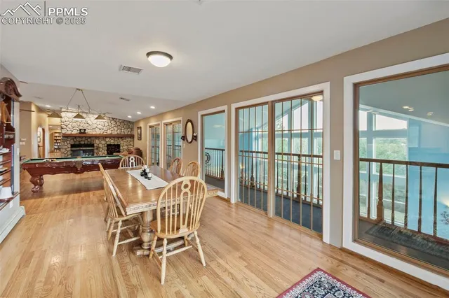 a dining room with furniture a chandelier and wooden floor