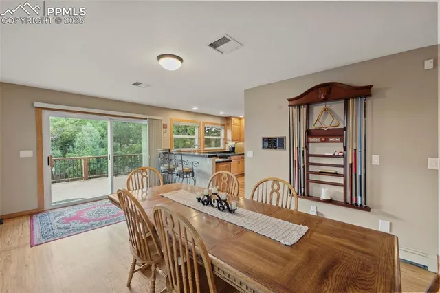 a view of a dining room with furniture a chandelier and wooden floor