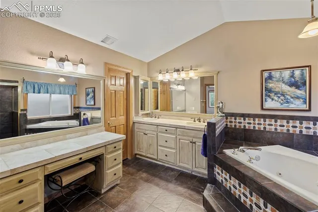 a bathroom with a sink a large mirror and a bathtub