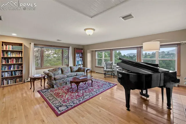 a living room with furniture and a floor to ceiling window