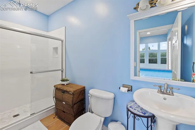 a bathroom with a toilet a sink and mirror