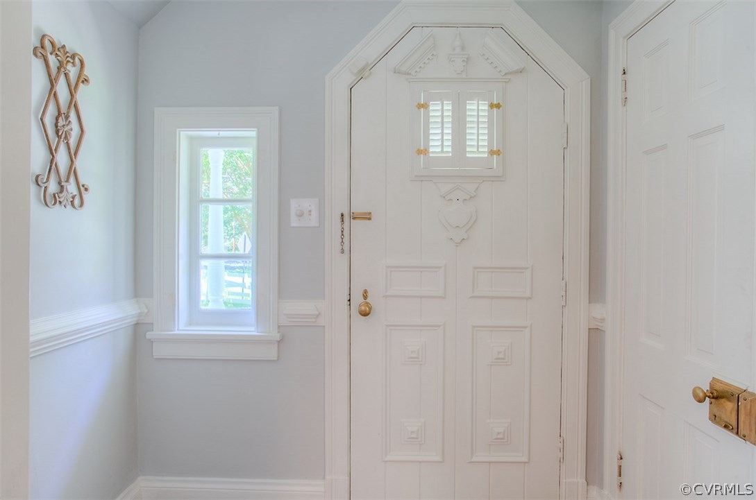 7110 Cherokee Road Richmond, VA 23225 - Photo 3 of 47 Entryway with ornate woodwork and trim and coat cl