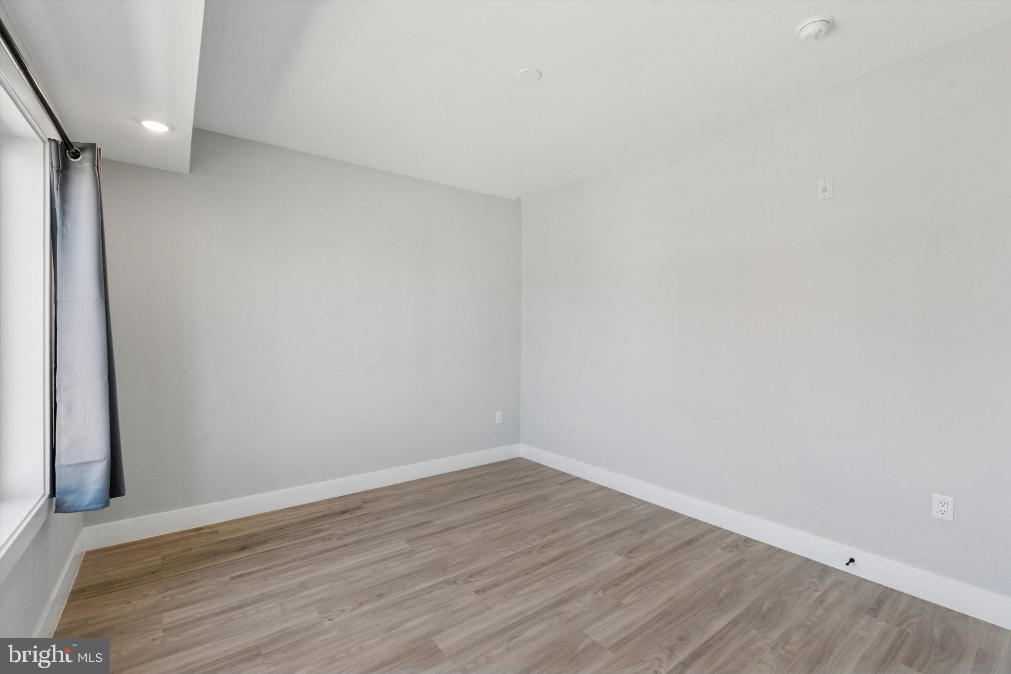 2401 North 2nd Street, Unit F2 Philadelphia, PA 19133 - Photo 11 of 13 a view of an empty room with wooden floor and a window