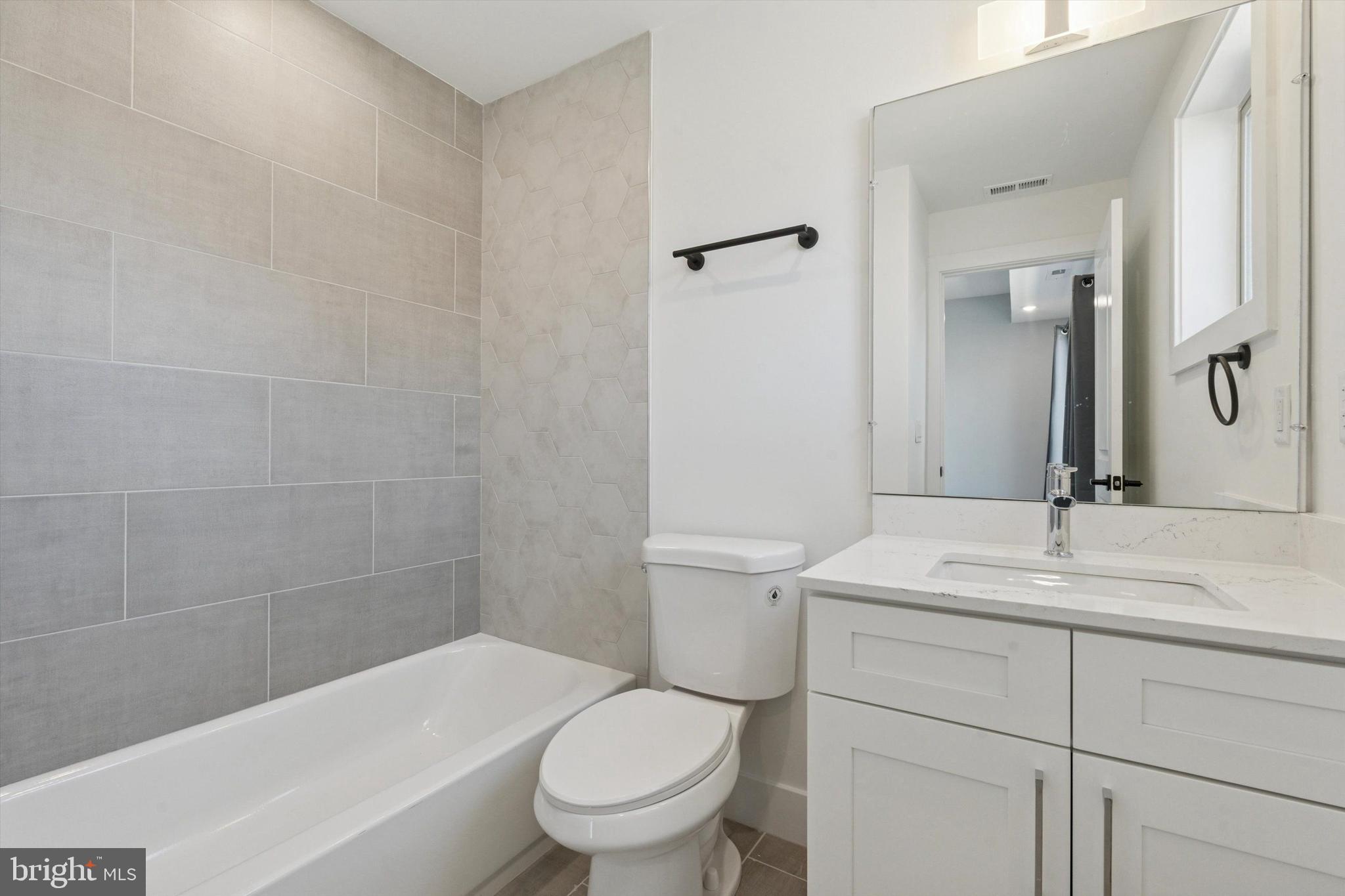 2401 North 2nd Street, Unit F2 Philadelphia, PA 19133 - Photo 12 of 13 a bathroom with a sink a toilet and shower