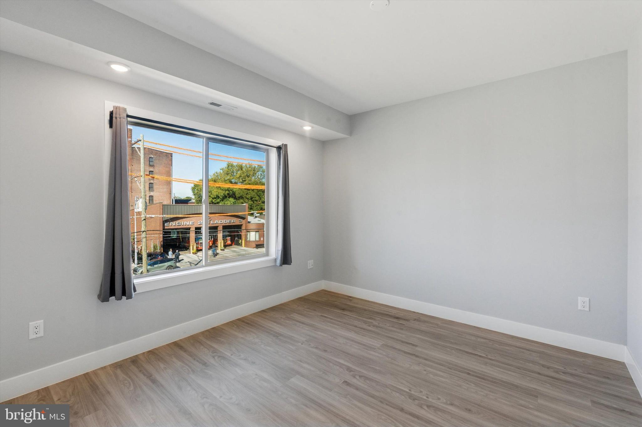 2401 North 2nd Street, Unit F2 Philadelphia, PA 19133 - Photo 4 of 13 a view of an empty room with wooden floor and a window