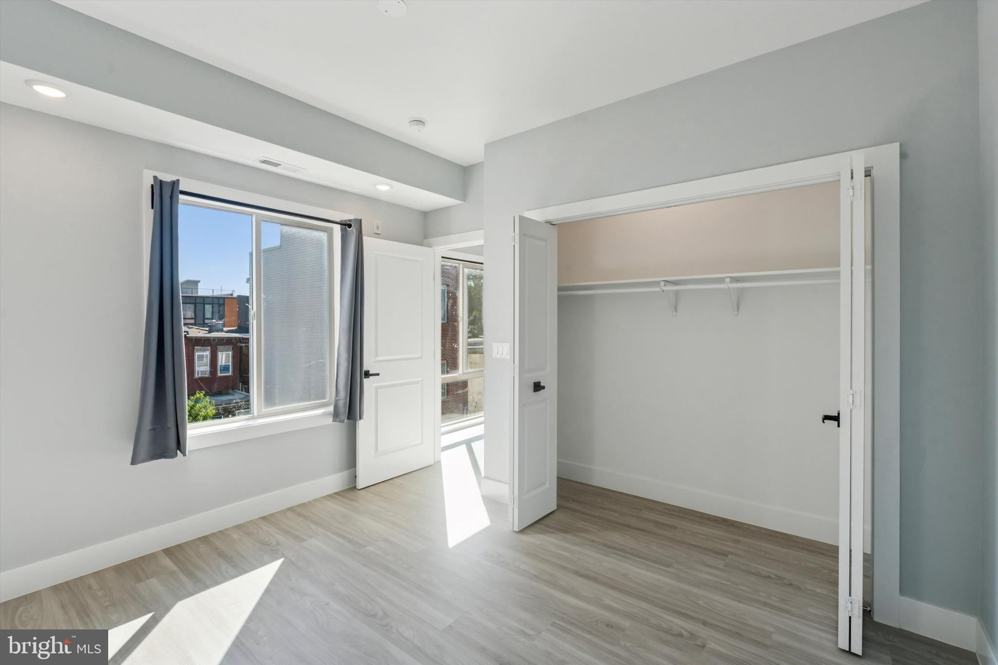 2401 North 2nd Street, Unit F2 Philadelphia, PA 19133 - Photo 6 of 13 a view of an empty room with wooden floor and a window