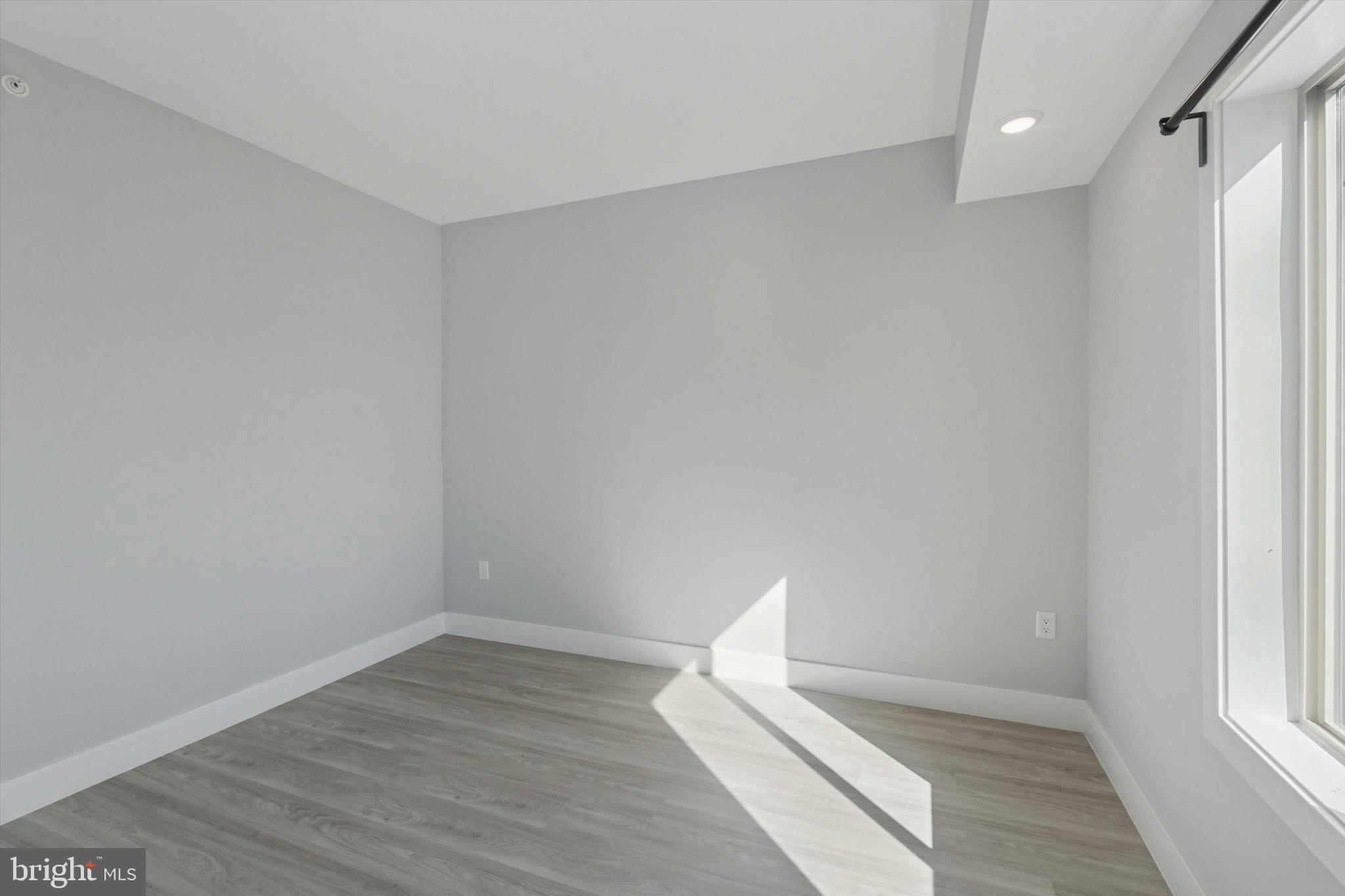 2401 North 2nd Street, Unit F2 Philadelphia, PA 19133 - Photo 10 of 13 a view of wooden floor and windows in a room