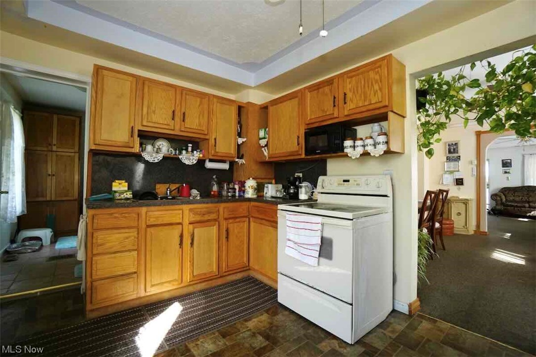 3756 Bosworth Road Cleveland, OH 44111 - Photo 10 of 23 Kitchen featuring oak cabinets electric stove, and a tray ceiling