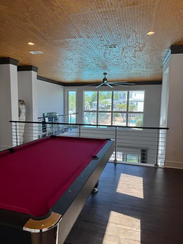 a room with pool table and windows