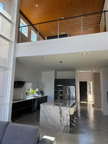 a living room with furniture and kitchen view