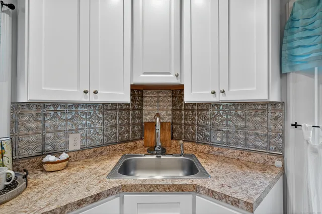 a kitchen with granite countertop a sink and a stove