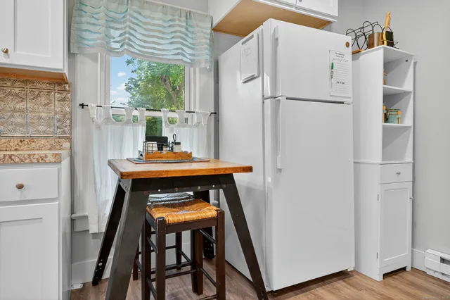 a white refrigerator freezer sitting in a kitchen